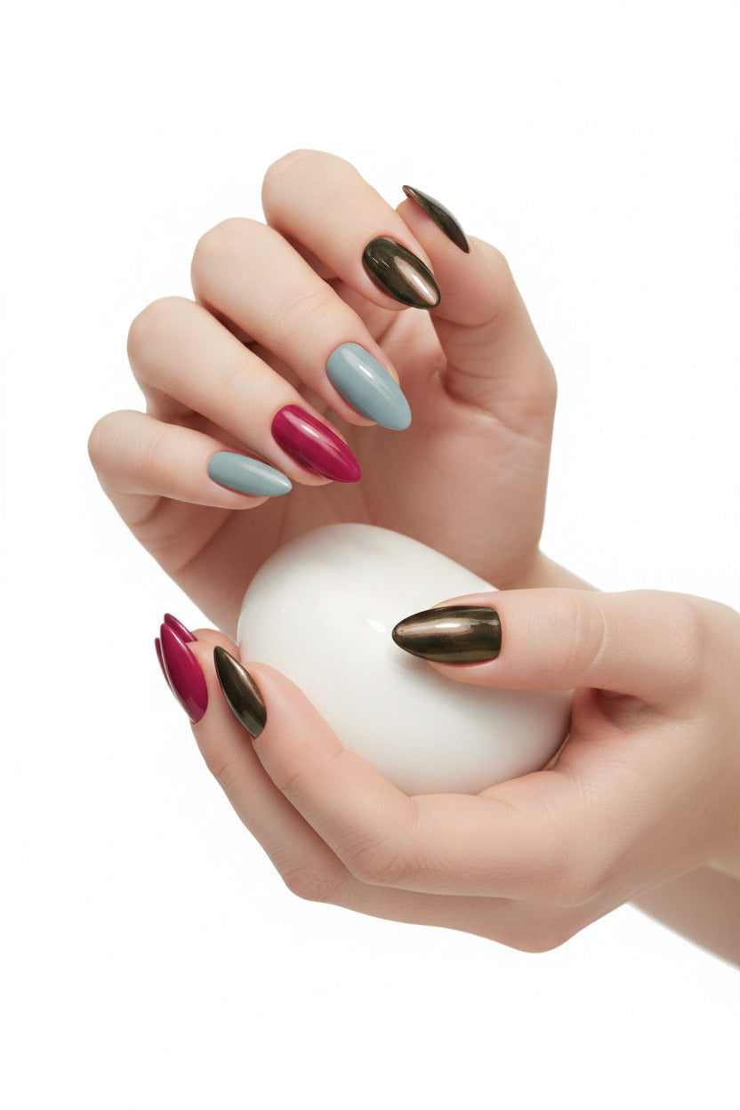 A clean product close-up of the Essentials Press-On Kit Midnight Black, Wine Berry, and Muted Slate Bundle by Bloom Gloss Co, showcasing fifteen matte almond fake nails arranged in rows of black, crimson red, and slate gray.