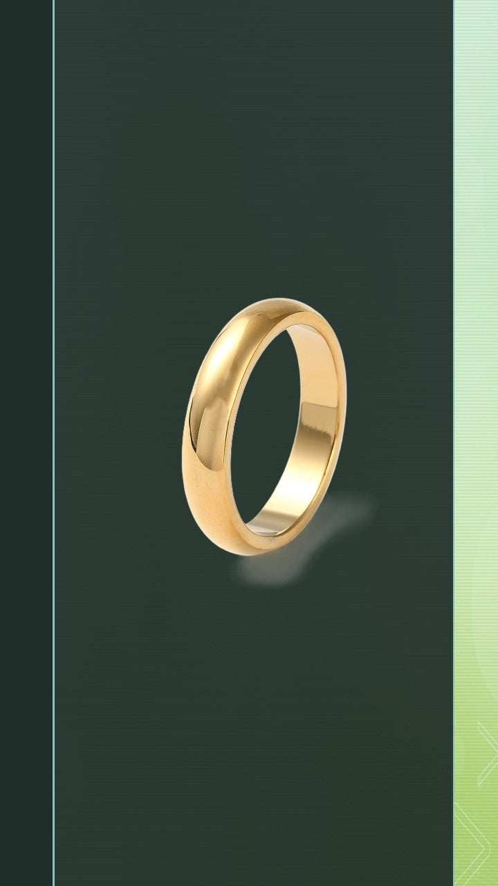 The BloomGloss 4mm Gold Studio Ring: a classic minimalist domed wedding band with a high-polish mirror finish, isolated on a dark olive green background.