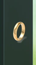 The BloomGloss 4mm Gold Studio Ring: a classic minimalist domed wedding band with a high-polish mirror finish, isolated on a dark olive green background.