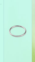 Shop the Classic Hoop Ring at Bloom Gloss Co. This delicate minimalist round silver stacking band features a sleek mirror finish, perfect for daily layering.
