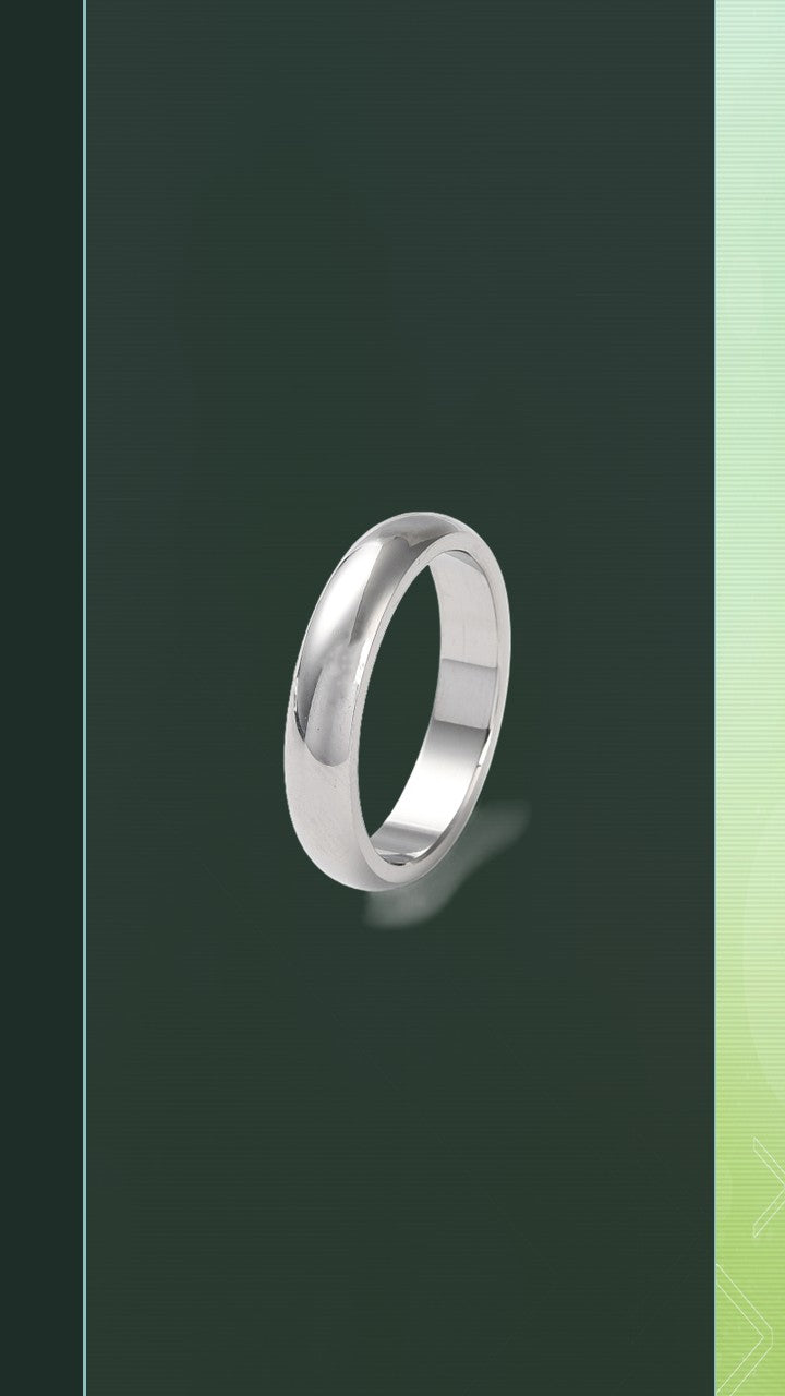 An angled product shot of The BloomGloss 4mm Silver Studio Ring, featuring a classic, plain stainless steel dome band with a flawless high-polished mirror finish resting on a light mint green background.