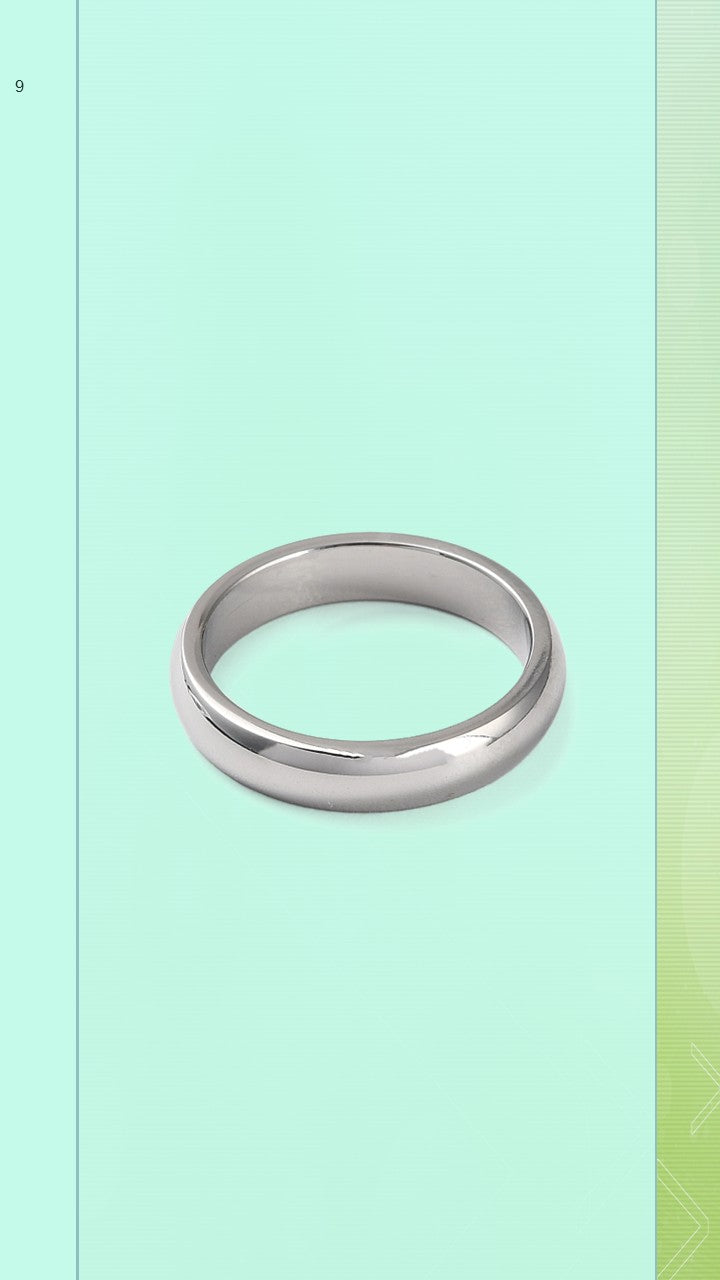 An angled product shot of The BloomGloss 4mm Silver Studio Ring, featuring a classic, plain stainless steel dome band with a flawless high-polished mirror finish resting on a light mint green background.