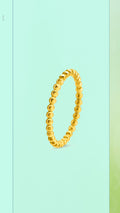 Elegant gold-plated thin stacking band with a textured, continuous halo pearl bubble design, shown close up to highlight the polished finish.
