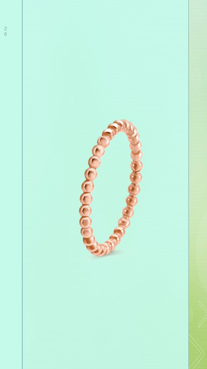 An angled product shot of The BloomGloss 4mm Rose Gold Studio Ring, featuring a classic, plain dome band with a flawless high-polished mirror finish resting on a light mint green background.