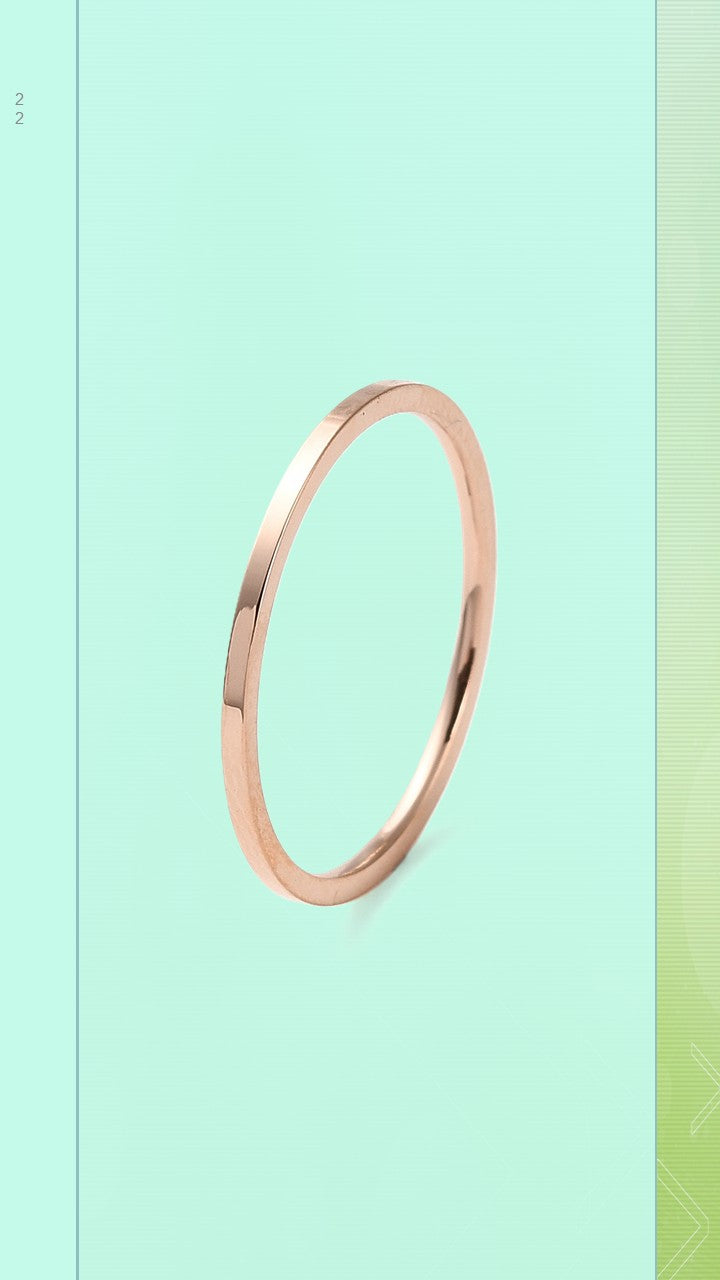The Pure Band by Bloom Gloss Co: a minimalist 1mm rose gold stacking ring featuring a smooth, polished square band profile with flat edges, displayed on a soft pastel green background.