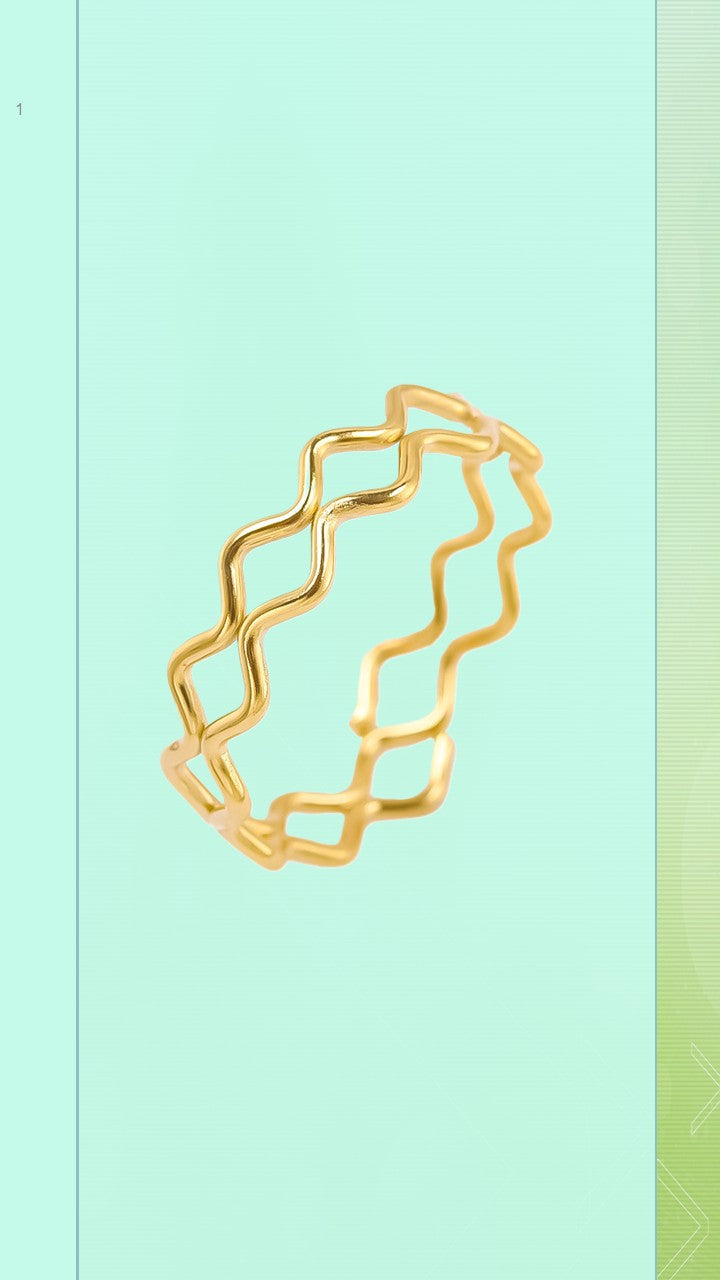 The Ripple Ring by Bloom Gloss Co: a minimalist 18K gold plated stackable band featuring a continuous wavy zigzag geometric pattern, isolated on a light mint green background.